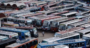 epa03822701 A man walks in the bus terminal where hundrds of buses remain parked during the 48-hour country wide strike called by Jamaat-e-Islami at Mohakhali, in Dhaka, Bangladesh, 13 August 2013. Jamaat-e-Islami has called the shutdown in a protest against a High Court verdict that declared illegal the party's registration with the Election Commission.  EPA/ABIR ABDULLAH
